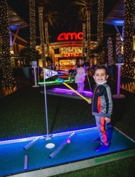 kid holding golf club 1734399707 Portable Mini Golf, LED 9 Hole